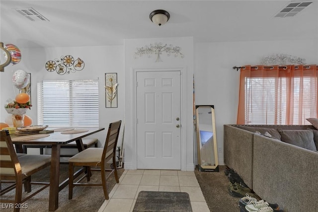 dining area featuring light tile patterned flooring and a healthy amount of sunlight