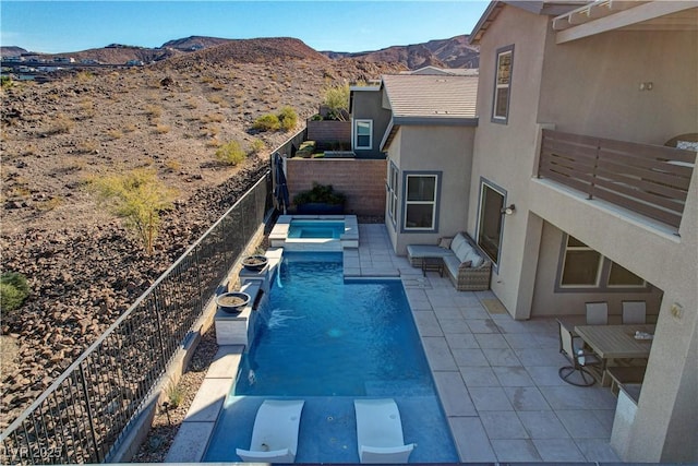 view of pool featuring a mountain view, an outdoor hangout area, and a patio