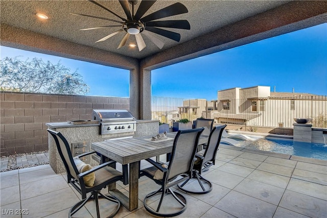 view of patio featuring a fenced in pool, a grill, ceiling fan, and exterior kitchen