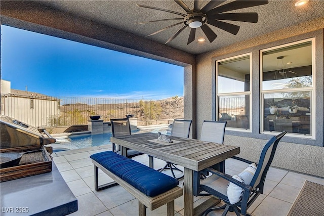 view of patio with a fenced in pool and ceiling fan