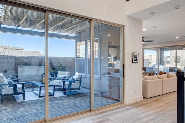 entryway with light hardwood / wood-style flooring and ceiling fan