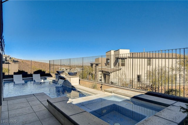 view of pool featuring pool water feature and a jacuzzi