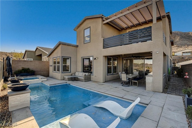 view of pool with a patio area, an in ground hot tub, and an outdoor living space