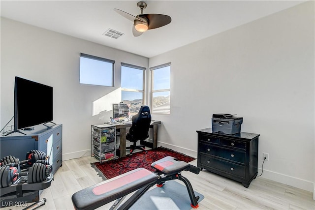 office with ceiling fan and light hardwood / wood-style floors