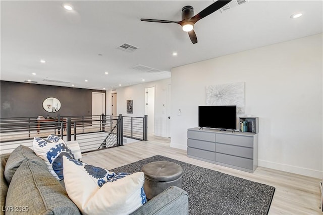 living room featuring ceiling fan and light wood-type flooring