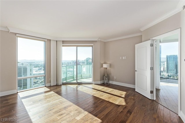 empty room with crown molding and dark hardwood / wood-style floors