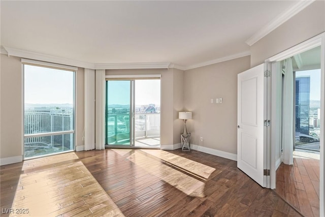 unfurnished room featuring a healthy amount of sunlight, ornamental molding, and dark hardwood / wood-style flooring