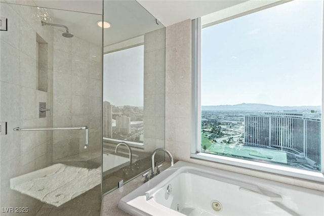 bathroom featuring plus walk in shower, a mountain view, and tile walls