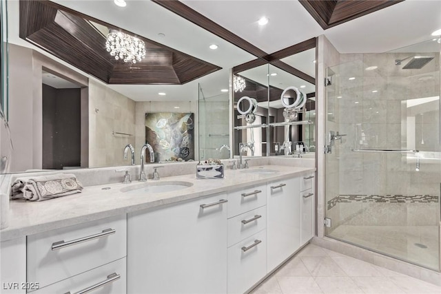 bathroom with a shower with door, vanity, a tray ceiling, tile patterned floors, and a chandelier