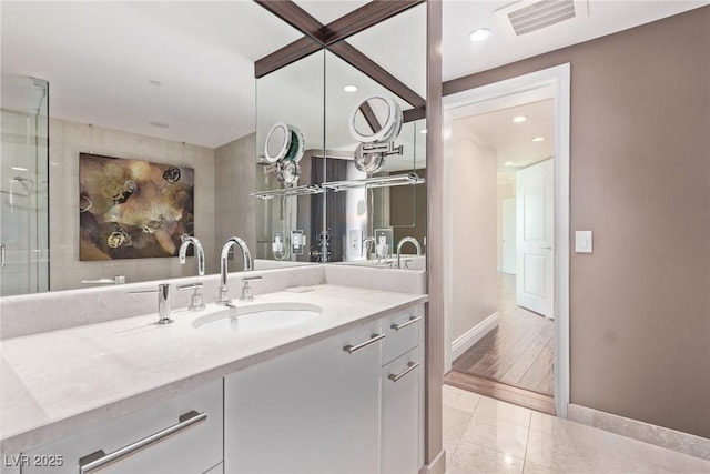 bathroom with vanity and an enclosed shower