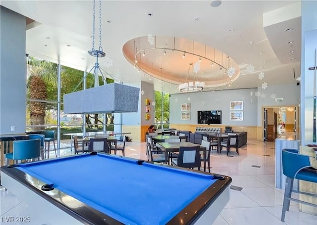 playroom with a healthy amount of sunlight, light tile patterned floors, pool table, and a tray ceiling