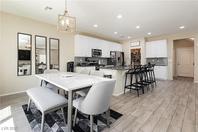 dining room with a notable chandelier and sink