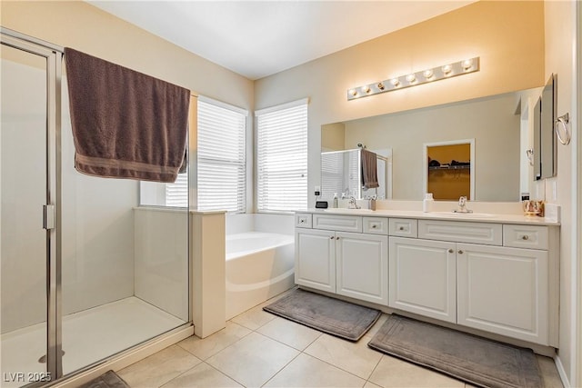 bathroom featuring shower with separate bathtub, vanity, and tile patterned floors