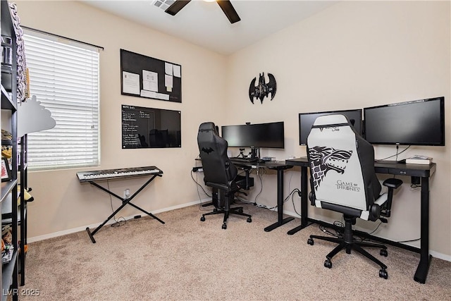 carpeted home office featuring ceiling fan