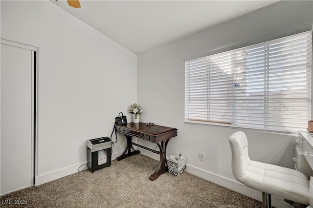 carpeted home office with lofted ceiling