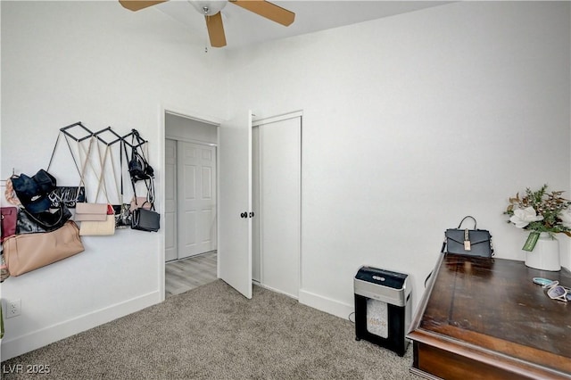 interior space featuring ceiling fan and light colored carpet