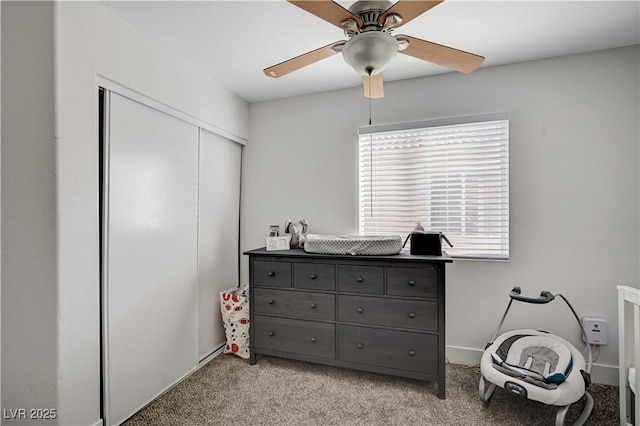 carpeted bedroom featuring ceiling fan and a closet