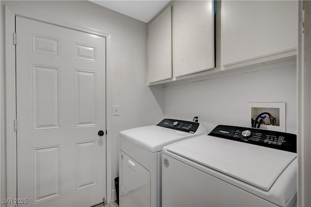 washroom featuring washing machine and clothes dryer and cabinets