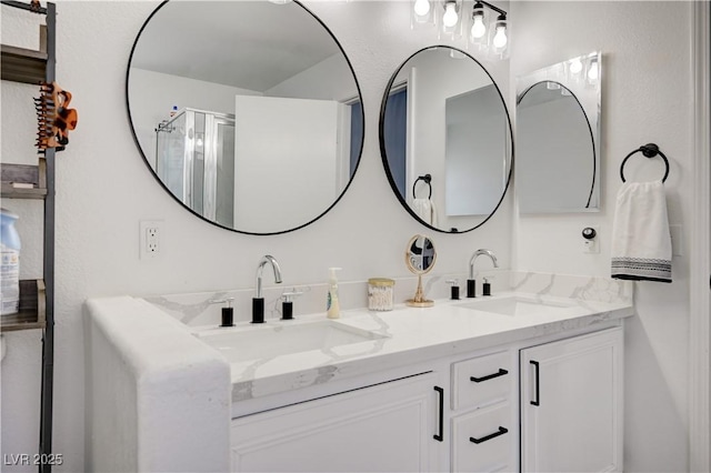 bathroom featuring vanity and a shower with door