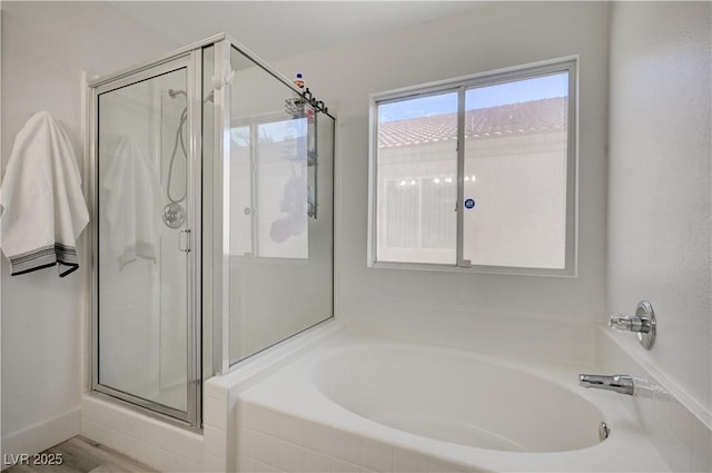 bathroom featuring shower with separate bathtub