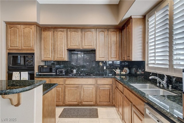 kitchen with backsplash, sink, black appliances, light tile patterned floors, and dark stone countertops