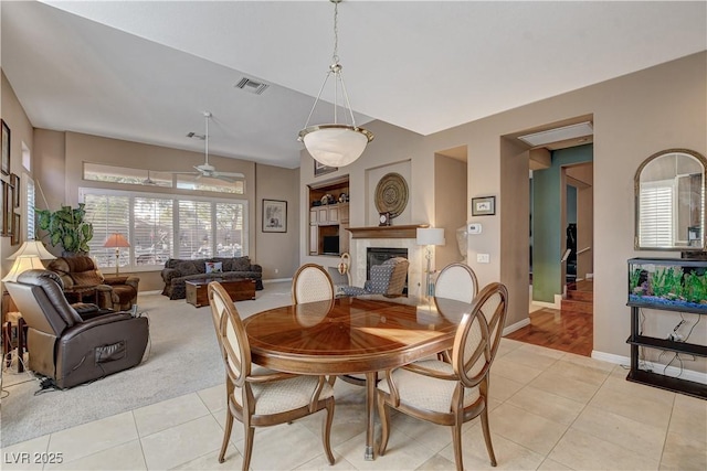 dining space with ceiling fan and light tile patterned floors