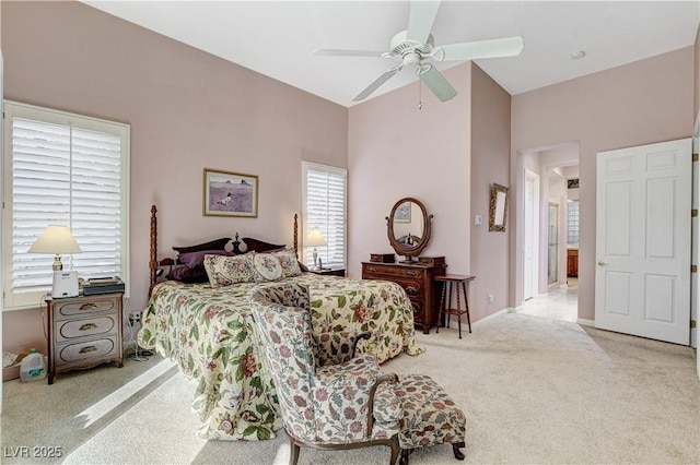 carpeted bedroom with ceiling fan and vaulted ceiling