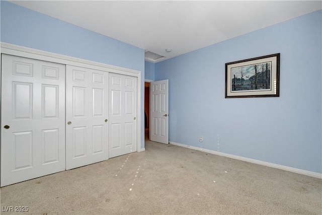 unfurnished bedroom featuring light colored carpet and a closet