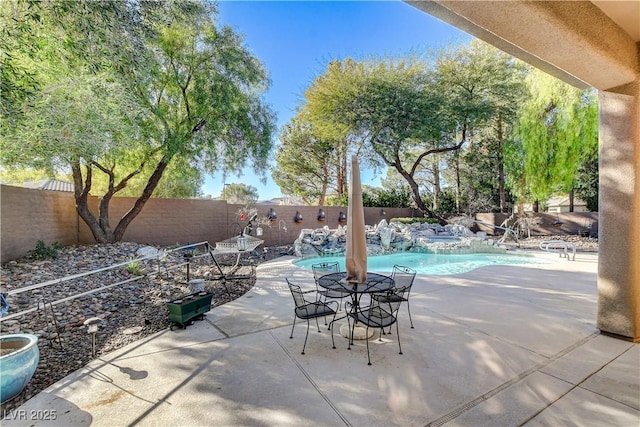 view of patio with a fenced in pool