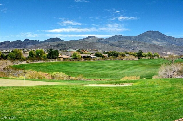 view of community featuring a lawn and a mountain view