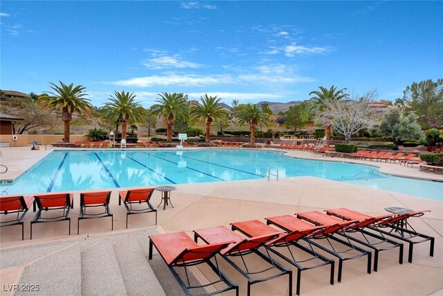 view of pool featuring a mountain view and a patio area