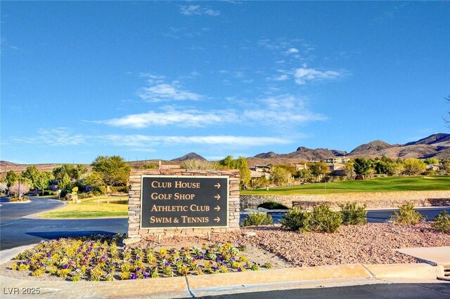 community / neighborhood sign with a mountain view