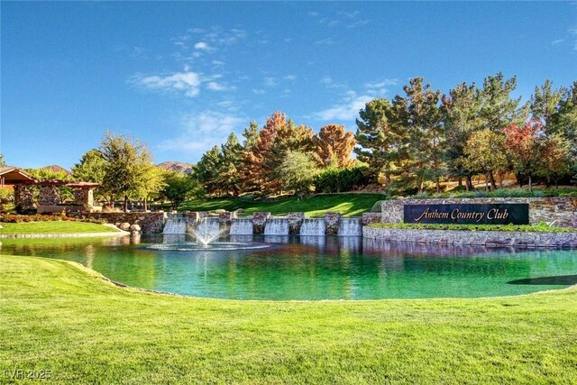 view of community featuring a water view and a lawn