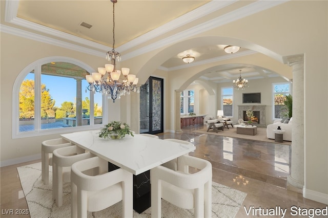 dining space with a wealth of natural light, ornamental molding, and a chandelier