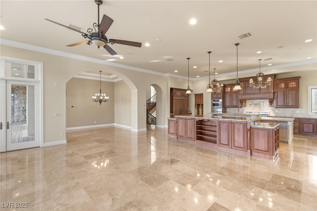 kitchen with crown molding, tasteful backsplash, a large island, and decorative light fixtures