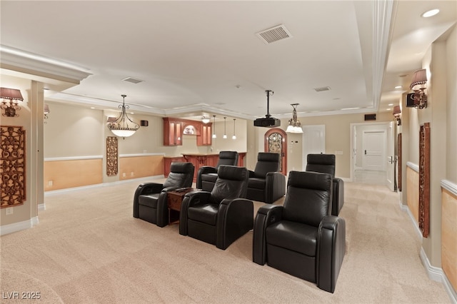 home theater room with light carpet, bar area, and crown molding