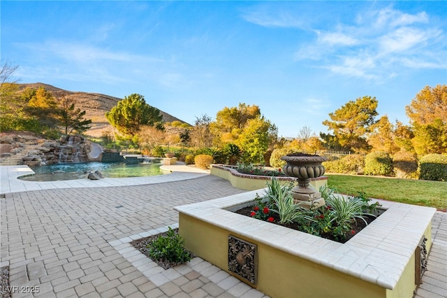 exterior space featuring a mountain view and a patio