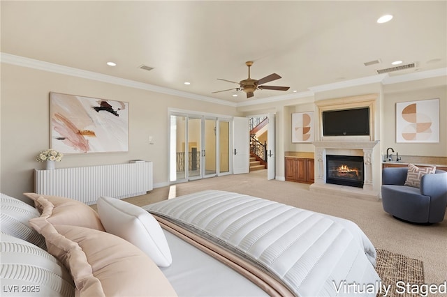 carpeted bedroom with ceiling fan, access to exterior, radiator heating unit, and ornamental molding