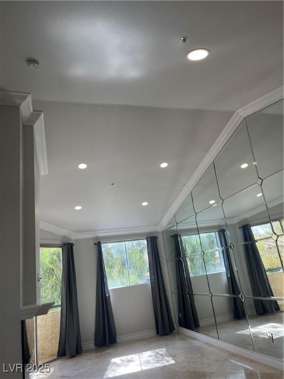 empty room with plenty of natural light and crown molding