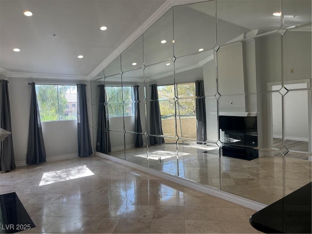 interior space featuring high vaulted ceiling, ornamental molding, recessed lighting, and baseboards