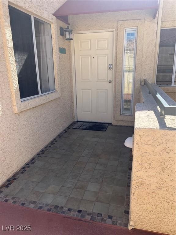 property entrance featuring stucco siding