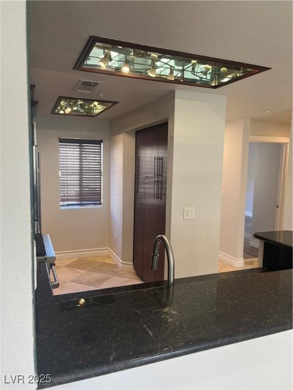 bathroom featuring baseboards, visible vents, and a sink