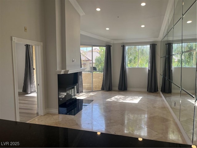 unfurnished living room featuring a tiled fireplace, recessed lighting, crown molding, and baseboards