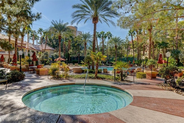 view of pool with a patio area and a hot tub