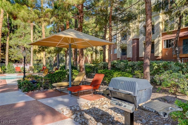 view of property's community featuring a patio area and a pool