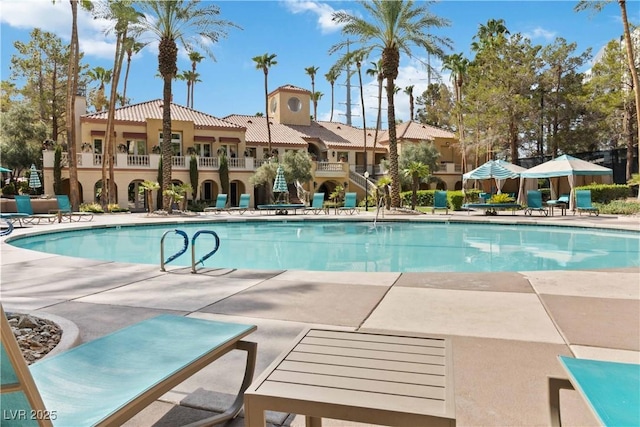 community pool with a patio area