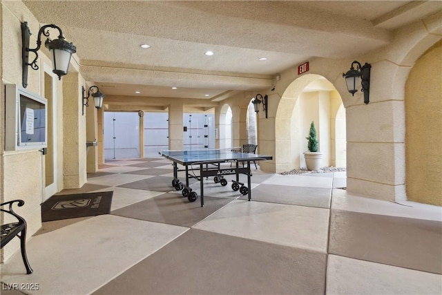 recreation room with a textured ceiling and recessed lighting