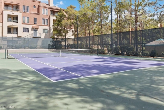 view of tennis court with fence