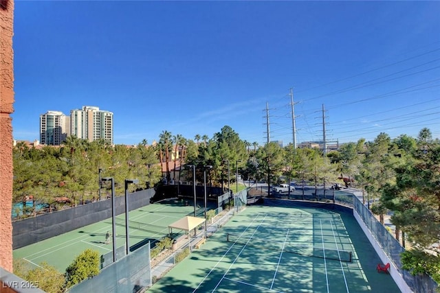 view of tennis court with fence