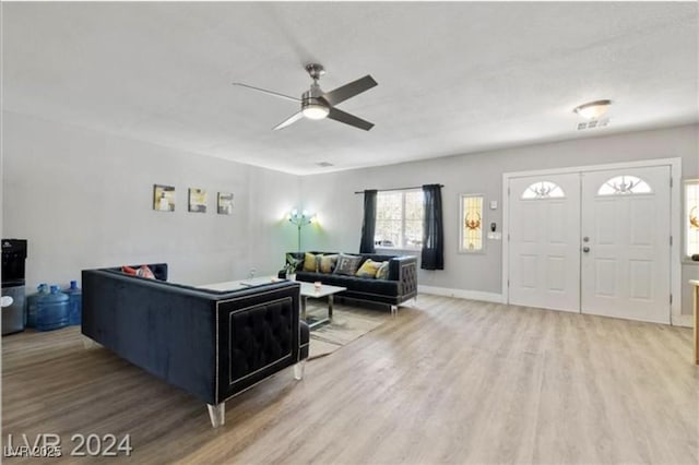 living room with hardwood / wood-style flooring and ceiling fan